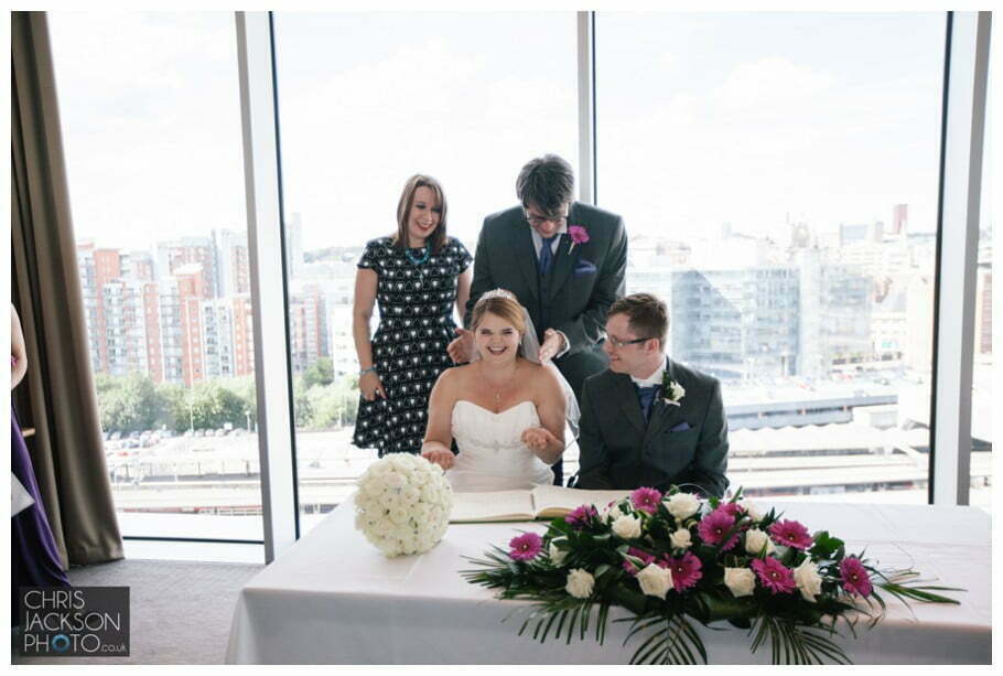 Doubletree by Hilton Wedding Photographer Leeds City Centre Wedding by Chris & Hazel Wedding photography - Tina & Sam 061 bride and groom signing of the register witness leeds city skyline leeds doubletree by hilton