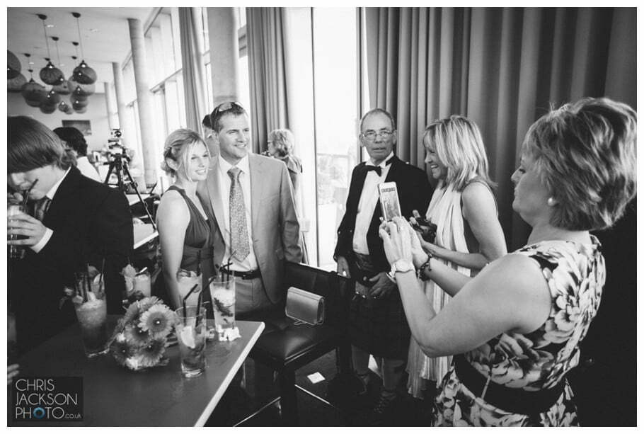 Doubletree by Hilton Wedding Photographer Leeds City Centre Wedding by Chris & Hazel Wedding photography - Tina & Sam 072 guests taking photographs at wedding leeds