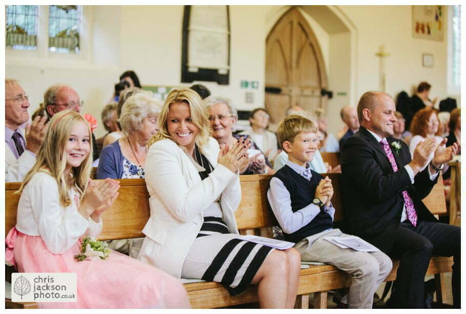 York Castle Museum Wedding Photographer York - Chris & Hazel Wedding Photography - Rory Dalgliesh & Rebecca Weinkauf 052 wedding ceremony guests reaction clapping smiling york heslington church wedding day weddings documentary york wedding photographer chris and hazel wedding photography