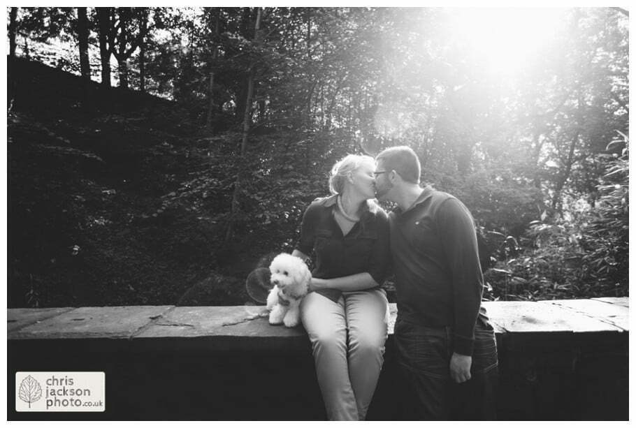 manchester Engagement Session Stamford Park ashton under lyne pre wedding photography couple forest trees dog dogs sat on wall kissing woodland chris and hazel wedding photography
