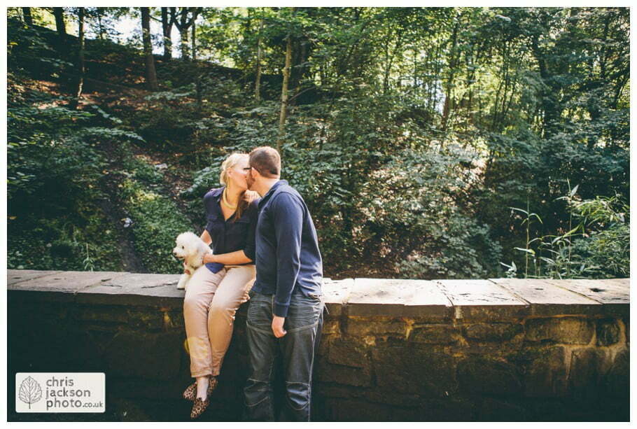manchester Engagement Session Stamford Park ashton under lyne pre wedding photography couple forest trees dog dogs sat on wall kiss woodland chris and hazel wedding photography
