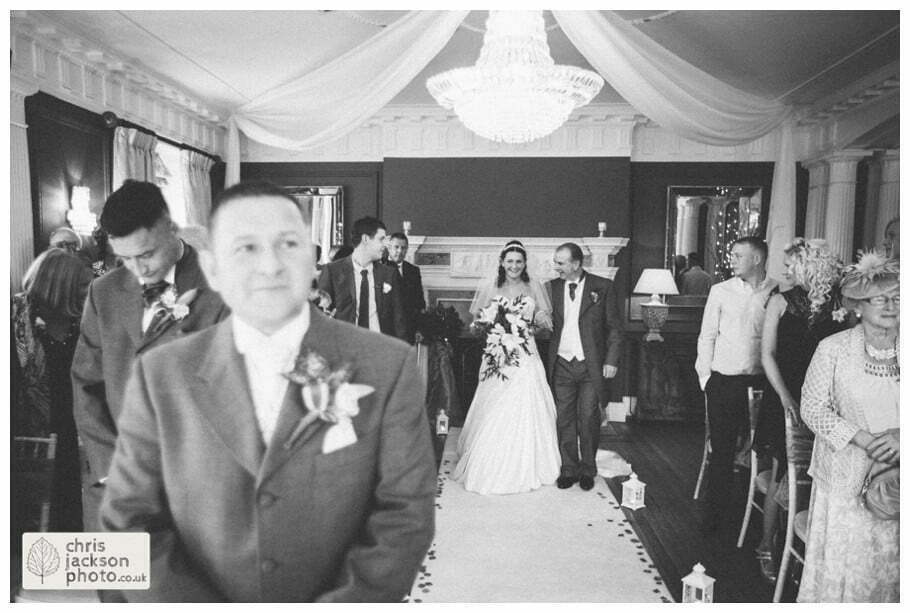 bride and father of bride walking down aisle into wedding ceremony room ballroom documentary reportage Eaves Hall Wedding Photographer Lancashire Clitheroe Wedding Photography by Chris & Hazel Wedding Photography - Steph Blight Steph Duxbury & Iain Duxbury