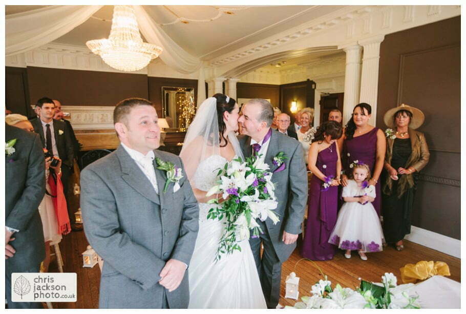 bride and father of bride kiss walking down aisle into wedding ceremony room ballroom documentary reportage Eaves Hall Wedding Photographer Lancashire Clitheroe Wedding Photography by Chris & Hazel Wedding Photography - Steph Blight Steph Duxbury & Iain Duxbury