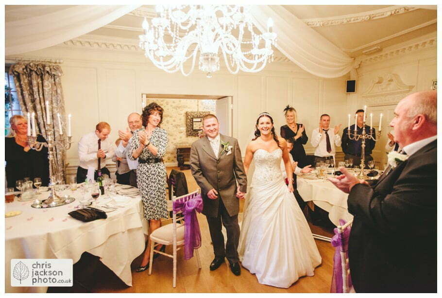 bride and groom entering wedding reception guests wedding breakfast room documentary reportage Eaves Hall Wedding Photographer Lancashire Clitheroe Wedding Photography by Chris & Hazel Wedding Photography - Steph Blight Steph Duxbury & Iain Duxbury