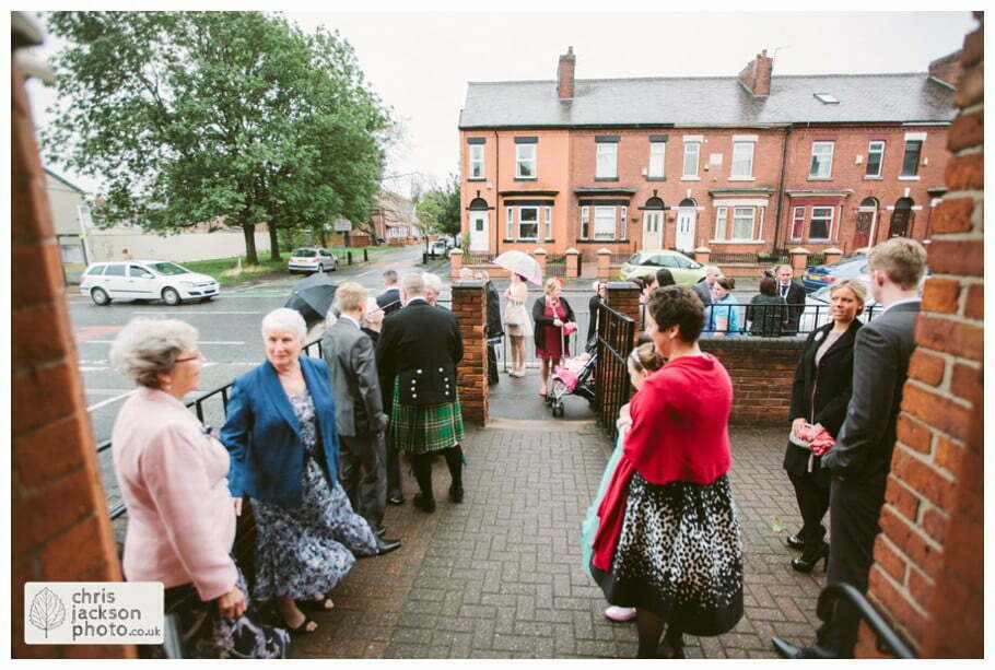 Manchester Wedding Photographer St Anne's Church Wedding Photographer Dukinfield Town Hall Wedding Photography by Chris & Hazel Katrina & John 007 wedding guests outside church St Annes church St. Anne's church openshaw wedding photographer by Manchester Wedding Photographer Chris & Hazel