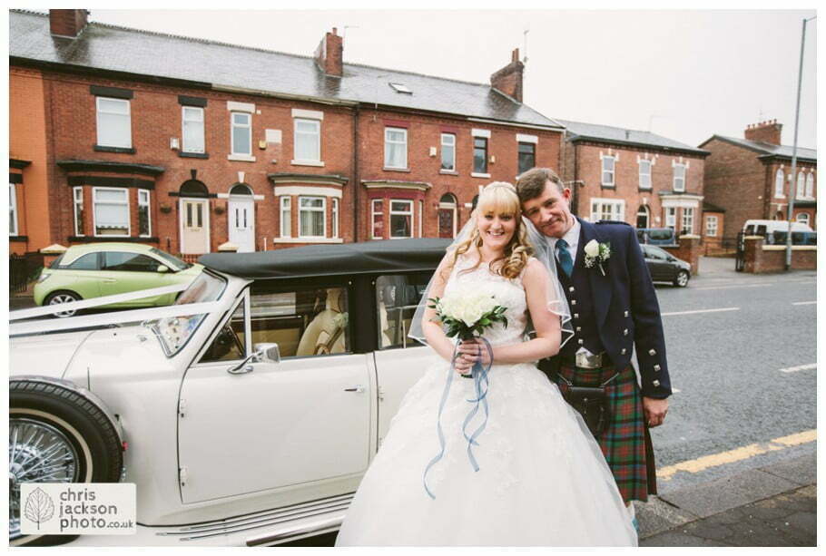 Manchester Wedding Photographer St Anne's Church Wedding Photographer Dukinfield Town Hall Wedding Photography by Chris & Hazel Katrina & John 022 bride and father next to wedding car outside church St Annes church St. Anne's church openshaw wedding photographer by Manchester Wedding Photographer Chris & Hazel