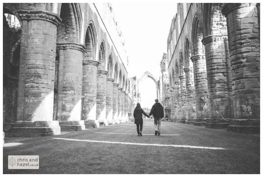 Rippon engagement photography wedding photographer Fountains Abbey yorkshire wedding photographer chris and hazel ruins couple walking