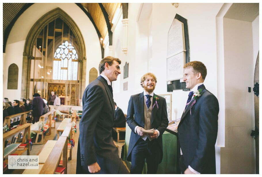 groom and ushers with guests inside heslington church documentary wedding photography ben frankie wedding photographer heslington church wedding york wedding photography wedding winter chris and hazel wedding photography york