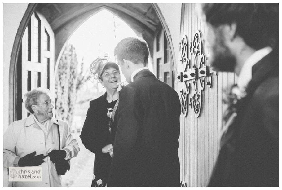 groom and ushers with guests inside heslington church documentary wedding photography ben frankie wedding photographer heslington church wedding york wedding photography wedding winter chris and hazel wedding photography york