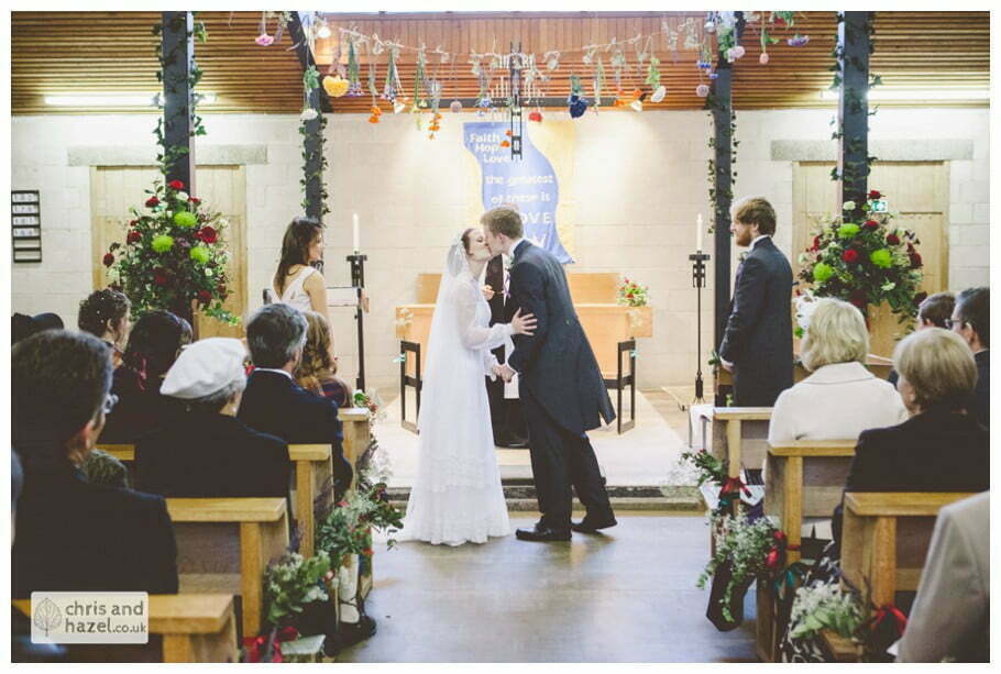 bride and groom at alter first kiss heslington church documentary wedding photography ben frankie wedding photographer heslington church wedding york wedding photography wedding winter chris and hazel wedding photography york