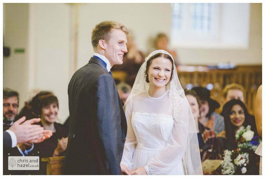 bride and groom at alter heslington church documentary wedding photography ben frankie wedding photographer heslington church wedding york wedding photography wedding winter chris and hazel wedding photography york