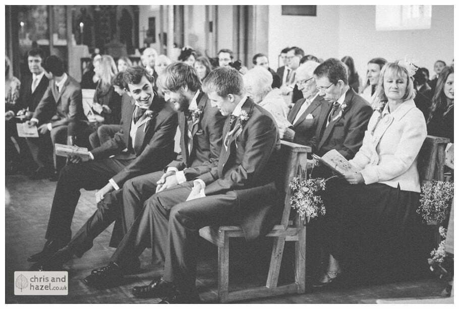 groom and ushers with guests inside heslington church documentary wedding photography benfrankie wedding photographer heslington church wedding york wedding photography wedding winter chris and hazel wedding photography york