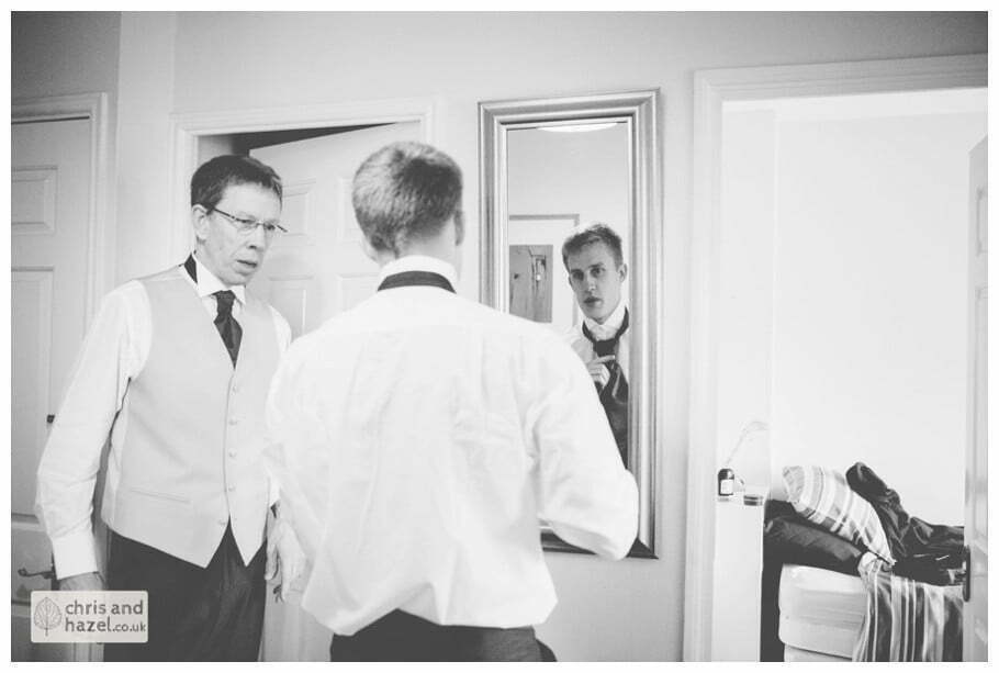 groom tying cravat getting ready preparations york city centre documentary wedding photography ben frankie wedding photographer york wedding photography wedding winter chris and hazel wedding photography york
