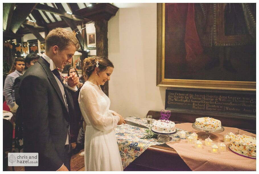cake cutting ben frankie merchant adventurers hall york wedding photography bride and groom christmas wedding winter chris and hazel wedding photography york