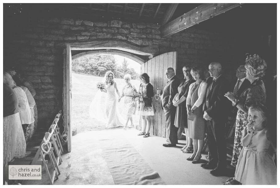 bride walking down aisle enter humanist wedding ceremony in barn documentary Wedding Photographer Harrogate Wedding Photography Braisty Estate by Chris and Hazel Wedding Photography Jonny Dunn Stef Brown