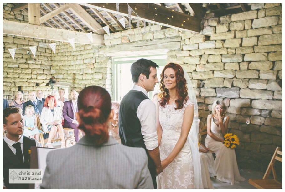 bride and groom at altar humanist wedding ceremony in barn documentary Wedding Photographer Harrogate Wedding Photography Braisty Estate by Chris and Hazel Wedding Photography Jonny Dunn Stef Brown