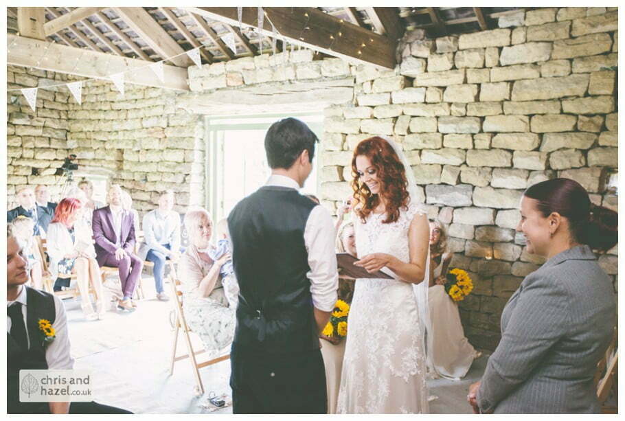 bride and groom at altar humanist wedding ceremony in barn documentary Wedding Photographer Harrogate Wedding Photography Braisty Estate by Chris and Hazel Wedding Photography Jonny Dunn Stef Brown
