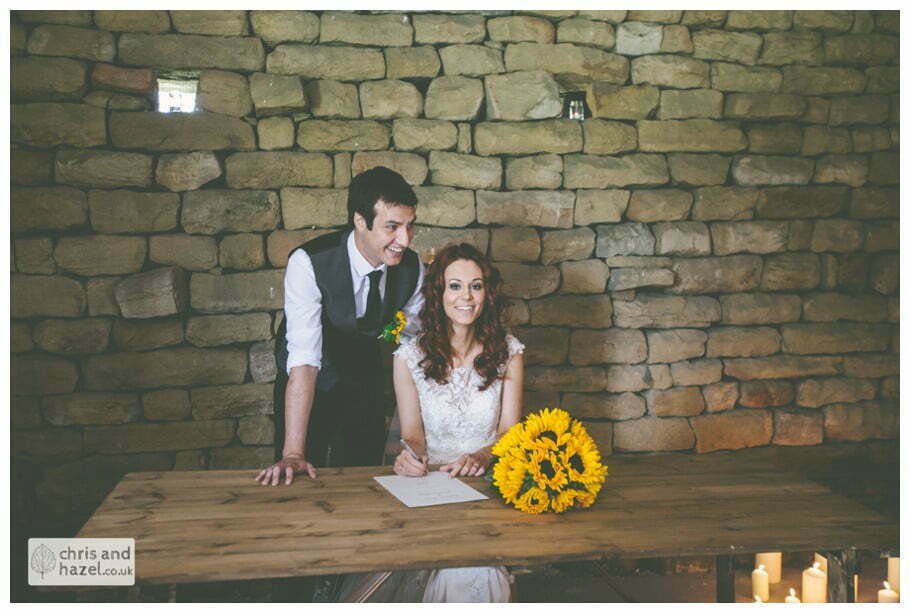 bride and groom sign register humanist wedding ceremony in barn documentary Wedding Photographer Harrogate Wedding Photography Braisty Estate by Chris and Hazel Wedding Photography Jonny Dunn Stef Brown