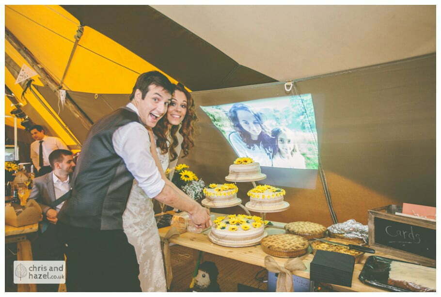 bride groom cutting wedding cake sunflower papkata tipi teepee rustic wedding theme hessian documentary Wedding Photographer Harrogate Wedding Photography Braisty Estate by Chris and Hazel Wedding Photography Jonny Dunn Stef Brown