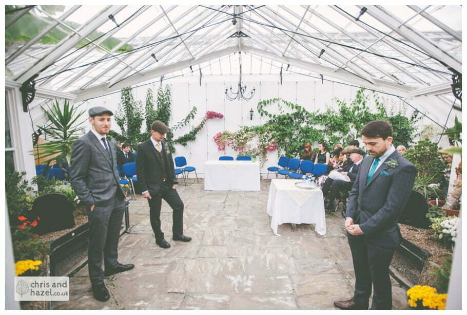 groom waiting at altar wedding ceremony in greenhouse conservatory documentary Hull Wedding Photographer Bishop Burton College Wedding Photography Hull by Chris and Hazel Wedding Photography Ross laurelin Matulis