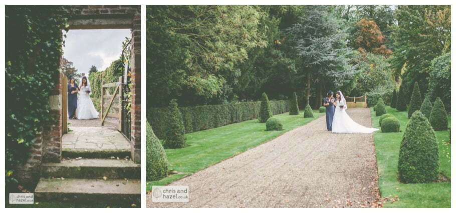 bride walking with mother of bride down aisle wedding ceremony in greenhouse conservatory documentary Hull Wedding Photographer Bishop Burton College Wedding Photography Hull by Chris and Hazel Wedding Photography Ross laurelin Matulis