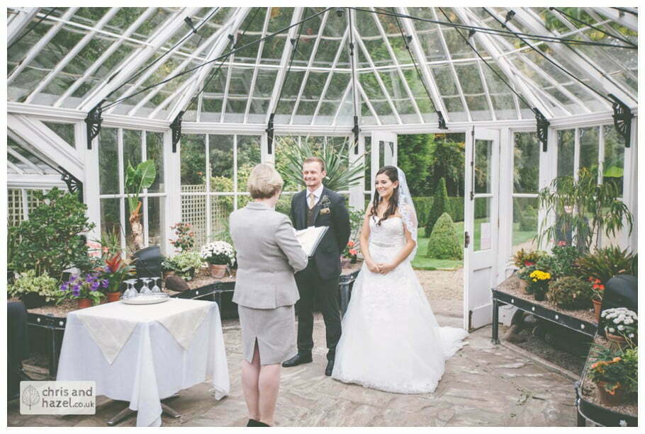 bride and groom vows wedding ceremony in greenhouse conservatory documentary Hull Wedding Photographer Bishop Burton College Wedding Photography Hull by Chris and Hazel Wedding Photography Ross laurelin Matulis