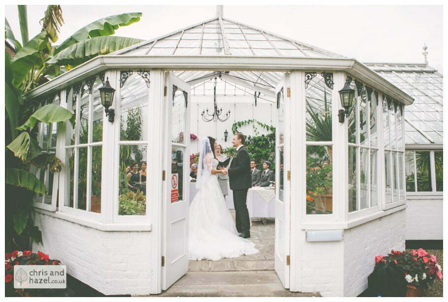 bride and groom vows wedding ceremony in greenhouse conservatory documentary Hull Wedding Photographer Bishop Burton College Wedding Photography Hull by Chris and Hazel Wedding Photography Ross laurelin Matulis