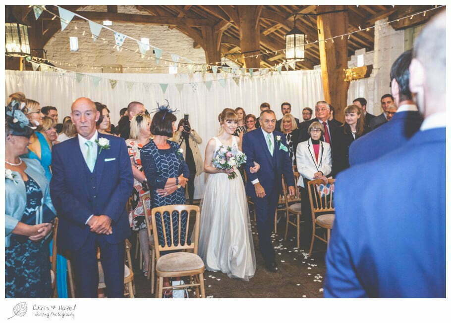 bride walking down aisle, bride entering wedding ceremony, barn, documentary wedding photography, Keighley ,Wedding Photographer, East Riddlesden Hall, Wedding Photography, Chris and Hazel Wedding Photography, Craig beasley, Stephanie Stubbs,