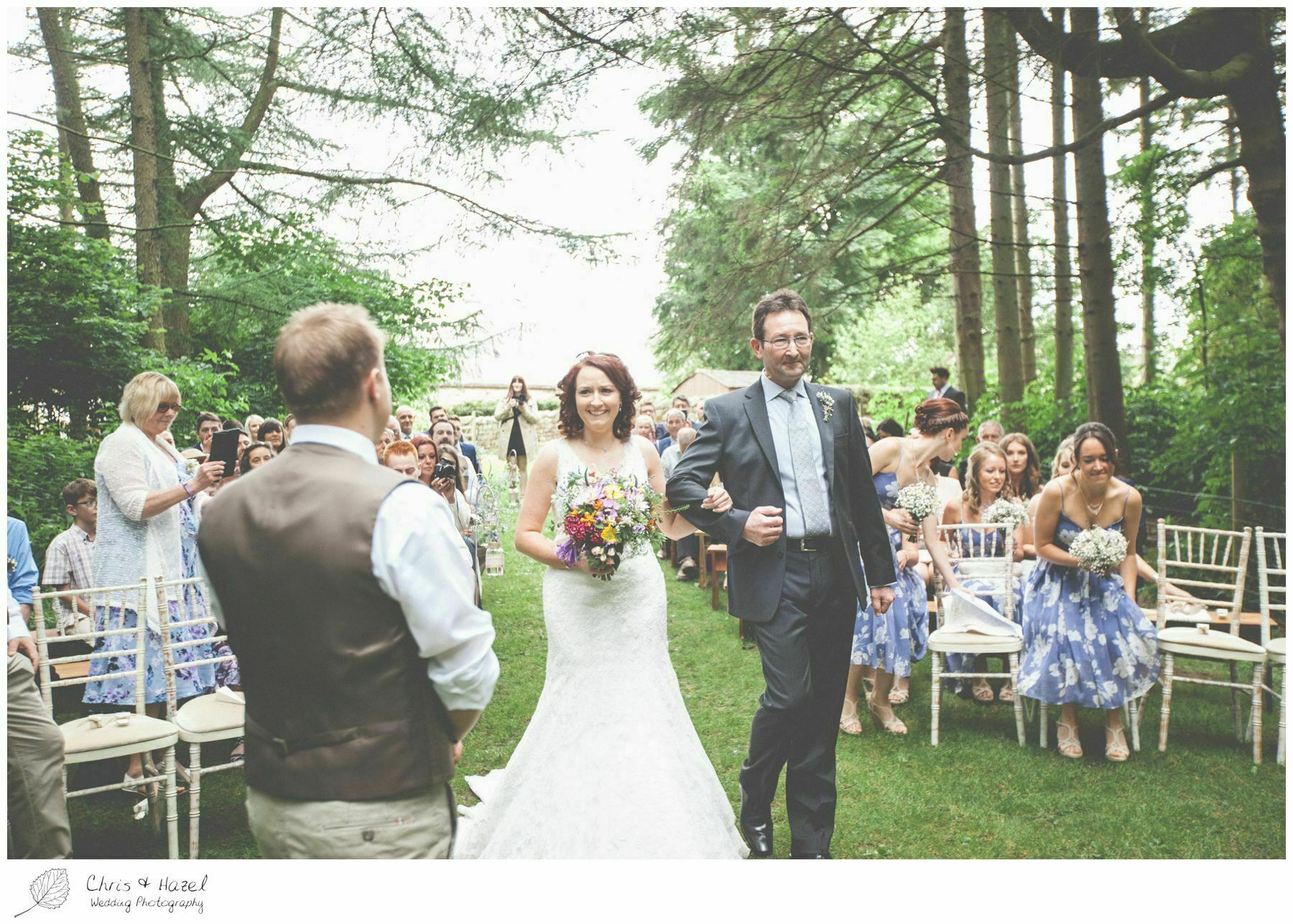 bride walking down aisle with father woodland ceremony, woodland, forest, ceremony, outdoor, forest wedding, woodland wedding, eco wedding, love letters, wedding, Eccup Wedding Photographer, Lineham Farm, Wedding Photography Leeds, Chris and Hazel Wedding Photography, Richard Wyatt, Laura Kelly