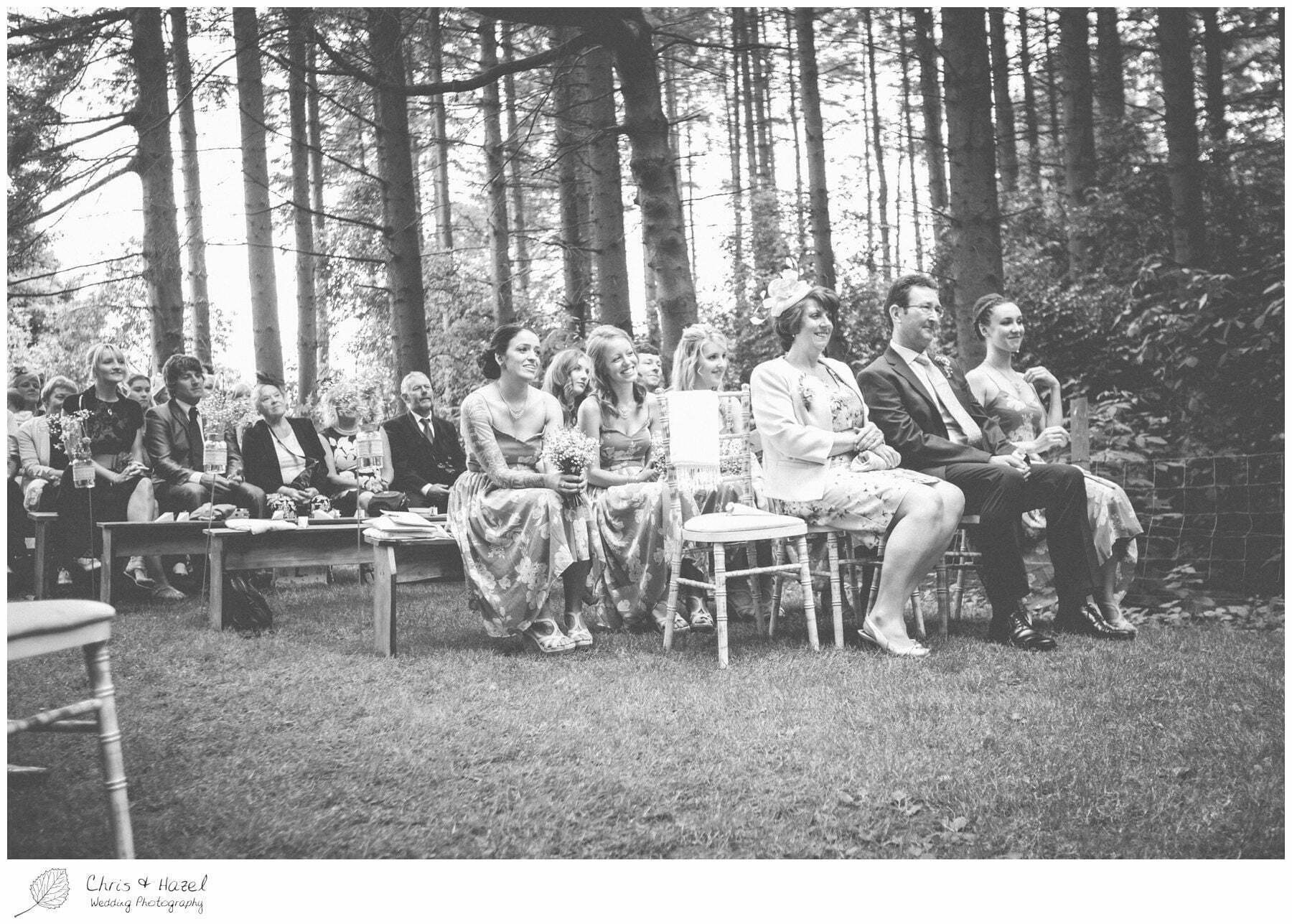 bridesmaids during ceremony, woodland ceremony, woodland, forest, ceremony, outdoor, forest wedding, woodland wedding, eco wedding, love letters, wedding, Eccup Wedding Photographer, Lineham Farm, Wedding Photography Leeds, Chris and Hazel Wedding Photography, Richard Wyatt, Laura Kelly
