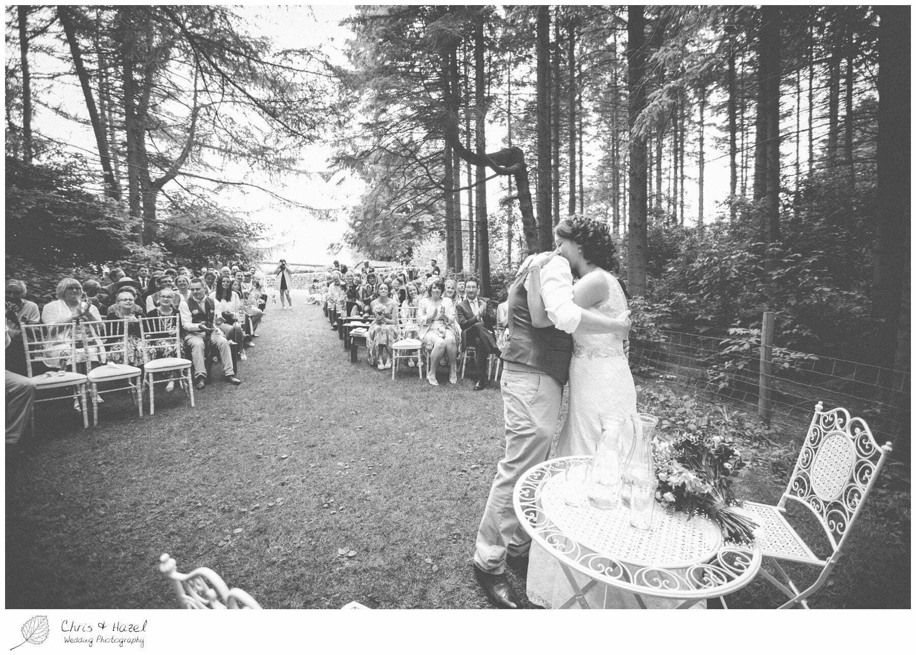 bride and groom first kiss, woodland ceremony, woodland, forest, ceremony, outdoor, forest wedding, woodland wedding, eco wedding, love letters, wedding, Eccup Wedding Photographer, Lineham Farm, Wedding Photography Leeds, Chris and Hazel Wedding Photography, Richard Wyatt, Laura Kelly