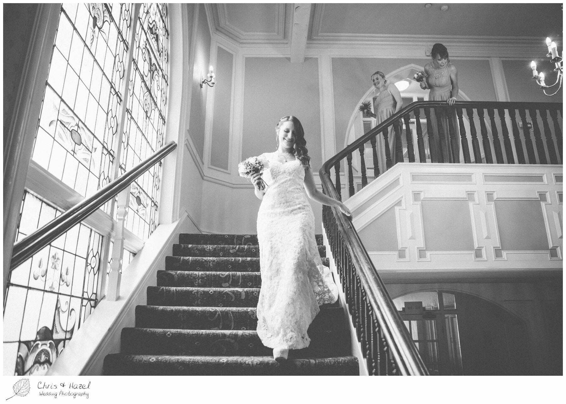 bride walking down the stairs, old staircase, wooden, old fashioned staircase, documentary wedding photography, the cairn hotel, the cairn hotel wedding photographer, wedding photography harrogate, wedding photography yorkshire, chris and hazel wedding photography, scott Dixon, caroline ellis, caroline Dixon