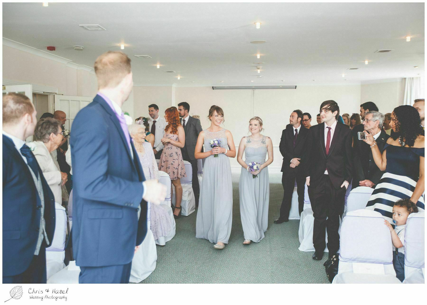 bridesmaids entering ceremony, bridesmaids walking down aisle, groom at altar, wedding ceremony, documentary wedding photography, the cairn hotel, the cairn hotel wedding photographer, wedding photography harrogate, wedding photography yorkshire, chris and hazel wedding photography, scott Dixon, caroline ellis, caroline Dixon