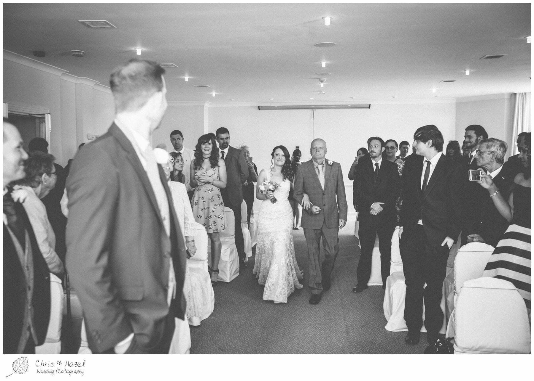 bride entering ceremony, bride walking down aisle, groom at altar, wedding ceremony, documentary wedding photography, the cairn hotel, the cairn hotel wedding photographer, wedding photography harrogate, wedding photography yorkshire, chris and hazel wedding photography, scott Dixon, caroline ellis, caroline Dixon