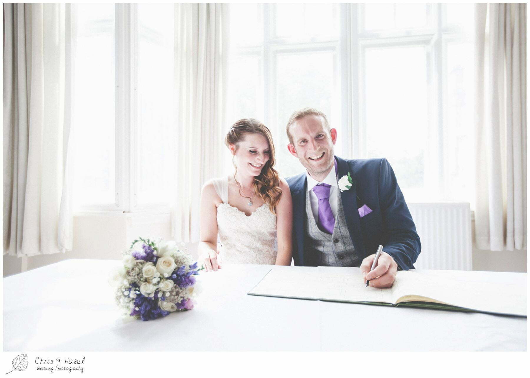 bride and groom sign register, signing register, wedding ceremony, documentary wedding photography, the cairn hotel, the cairn hotel wedding photographer, wedding photography harrogate, wedding photography yorkshire, chris and hazel wedding photography, scott Dixon, caroline ellis, caroline Dixon